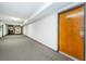 Condo hallway with wood door and carpet flooring at 2587 Countryside Blvd # 6303, Clearwater, FL 33761