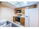 Efficient kitchen with wood cabinets and appliances at 2587 Countryside Blvd # 6303, Clearwater, FL 33761