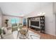 Virtually staged living room with green sofas and built-in shelving at 2587 Countryside Blvd # 6303, Clearwater, FL 33761