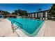 Community swimming pool with lounge chairs at 2587 Countryside Blvd # 6303, Clearwater, FL 33761
