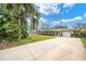 Landscaped front yard, driveway, and attached garage at 266 Snell Isle Ne Blvd, St Petersburg, FL 33704