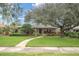 Single story home with large tree and landscaped yard at 266 Snell Isle Ne Blvd, St Petersburg, FL 33704