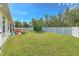Spacious backyard with a hot tub, playset, and white fence at 3019 124Th E Ave, Parrish, FL 34219