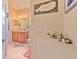 Clean bathroom with single vanity and decorative wall art at 3019 124Th E Ave, Parrish, FL 34219