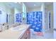 Bathroom with shower tub, wood vanity, and shark theme at 3019 124Th E Ave, Parrish, FL 34219