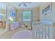 Bedroom featuring a crib, dresser, and soft rug at 3019 124Th E Ave, Parrish, FL 34219