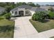 One-story home with gray roof, screened porch, and driveway at 3019 124Th E Ave, Parrish, FL 34219