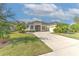 Single-story house with a large driveway and nicely landscaped yard at 3019 124Th E Ave, Parrish, FL 34219