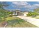 Single-story house with a large driveway and lush green lawn at 3019 124Th E Ave, Parrish, FL 34219