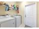 Laundry room with washer, dryer, and shelving at 3019 124Th E Ave, Parrish, FL 34219