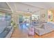 Living area with hardwood floors, sliding doors to lanai and pool at 3019 124Th E Ave, Parrish, FL 34219