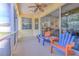 Relaxing screened porch with colorful chairs and view of the kitchen at 3019 124Th E Ave, Parrish, FL 34219