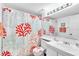 Bathroom with coral-themed shower curtain and updated vanity at 3141 Lake Pine Way # D2, Tarpon Springs, FL 34688