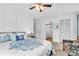 Spacious bedroom with ensuite bathroom access and a ceiling fan at 3141 Lake Pine Way # D2, Tarpon Springs, FL 34688