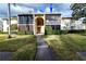 Exterior view of condo building with screened balcony at 3141 Lake Pine Way # D2, Tarpon Springs, FL 34688