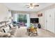 Living room with gray sectional, TV, and balcony access at 3141 Lake Pine Way # D2, Tarpon Springs, FL 34688