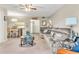Living room features gray sectional and kitchen pass-through at 3141 Lake Pine Way # D2, Tarpon Springs, FL 34688