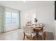 Bright dining room with wood table and striped chairs at 33174 Osprey Peak Way, San Antonio, FL 33576