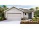 One-story home with a neutral color palette, two-car garage, and landscaping at 33174 Osprey Peak Way, San Antonio, FL 33576