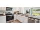 Modern kitchen with stainless steel appliances and gray countertops at 33174 Osprey Peak Way, San Antonio, FL 33576