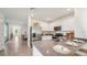 Open concept kitchen with island, stainless steel appliances, and view to dining area at 33174 Osprey Peak Way, San Antonio, FL 33576