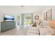 Bright living room featuring a comfy sectional sofa and a large TV at 33174 Osprey Peak Way, San Antonio, FL 33576