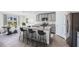 Modern kitchen with gray cabinets, granite counters, and an island at 33182 Osprey Peak Way, San Antonio, FL 33576