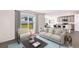 Open living area with light-colored sofa and access to kitchen at 33182 Osprey Peak Way, San Antonio, FL 33576