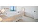 Bright bedroom with water view, dresser, and comfortable bed at 400 Island Way # 1204, Clearwater, FL 33767