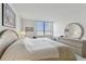 King-size bed in bedroom with large window and mirror at 400 Island Way # 1204, Clearwater, FL 33767
