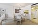 Charming dining area with chandelier and floral chairs at 400 Island Way # 1204, Clearwater, FL 33767