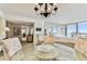 Spacious dining area with glass-top table and chandelier at 400 Island Way # 1204, Clearwater, FL 33767