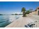 Steps leading to a waterfront deck with chairs at 400 Island Way # 1204, Clearwater, FL 33767