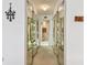 Long hallway with mirrored closet doors and carpet at 400 Island Way # 1204, Clearwater, FL 33767