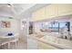 Kitchen with ocean view and white cabinets at 400 Island Way # 1204, Clearwater, FL 33767