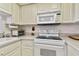 White kitchen with built-in microwave and oven at 400 Island Way # 1204, Clearwater, FL 33767