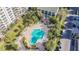 Aerial view of a community pool with surrounding lounge chairs and landscaping at 400 Island Way # 1204, Clearwater, FL 33767
