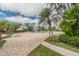 Inviting community pool with lounge chairs and tropical landscaping at 400 Island Way # 1204, Clearwater, FL 33767