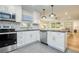 Modern kitchen featuring white cabinets, herringbone backsplash, and stainless steel appliances at 492 Santa Cruz Ne Pl # D, St Petersburg, FL 33703