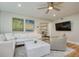 Living room with sectional sofa and large TV at 492 Santa Cruz Ne Pl # D, St Petersburg, FL 33703
