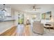 Living area with hardwood floors, kitchen, and access to patio at 492 Santa Cruz Ne Pl # D, St Petersburg, FL 33703