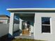 Covered patio with seating area, providing a relaxing outdoor space at 504 Magnolia Pointe Ct, Seffner, FL 33584