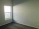 Bright bedroom with grey carpet and a large window at 504 Magnolia Pointe Ct, Seffner, FL 33584