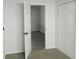 Bedroom with grey carpet, double door closet and access to another room at 504 Magnolia Pointe Ct, Seffner, FL 33584