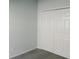 Simple bedroom with grey carpet and double door closet at 504 Magnolia Pointe Ct, Seffner, FL 33584