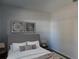 Cozy bedroom with a gray upholstered bed, nightstands, and stylish artwork at 504 Magnolia Pointe Ct, Seffner, FL 33584