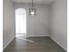 Simple dining room with hardwood floors and a modern light fixture at 504 Magnolia Pointe Ct, Seffner, FL 33584