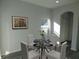 Casual dining area with a round glass table and four white chairs at 504 Magnolia Pointe Ct, Seffner, FL 33584