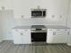 Modern kitchen with stainless steel appliances and granite countertops at 504 Magnolia Pointe Ct, Seffner, FL 33584