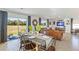 Dining area with wooden table and chairs, adjacent to living room at 5246 Salt Marsh Rd, Wimauma, FL 33598